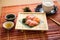 sashimi on a bamboo mat with dipping bowl
