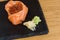 Sashimi composition of fish food, salmon fillets mounted in the shape of a cup, stuffed with caviar, plate served on a slab of