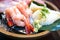 The sashimi set is beautifully arranged in a wooden plate. Japanese Cuisine Buffet. Chef`s Choice: shrimp, engawa, tuna and