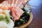 The sashimi set is beautifully arranged in a wooden plate. Japanese Cuisine Buffet. Chef`s Choice: tuna, engawa, shrimp and