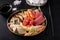 sashimi set of salmon, shrimp, tuna and eel on a black plate