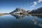 Sass de Putia reflects itself over a small alpine lake in Dolomites at evening