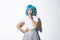 Sassy asian girl in blue wig share a secret, winking and shushing at camera with flirty expression, wearing blue short