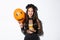 Sassy beautiful asian woman enjoying trick or treating, celebrating halloween, holding orange balloon and sweets