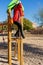 Sassy preteen girl pulling herself off a metal bar in a park. Fun concept