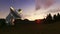 Satellite Antenna on Green Meadow, time lapse sunset, camera panning