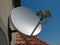 Satellite dish antenna over blue sky