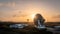 A satellite dish at Goonhilly Satellite Earth Station pointing skywards at sunset
