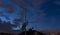 Satellite dish and TV antenna on rooftop at dusk