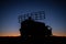 Satellite dishes or radio antennas against evening sky. Selective focus