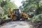 Sathyamangalam, Tamil Nadu, India - June 24, 2015: An excavator doing roadwork in the middle of the Sathyamangalam forest.