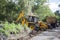 Sathyamangalam, Tamil Nadu, India - June 24, 2015: An excavator doing roadwork in the middle of the Sathyamangalam forest.