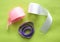 Satin ribbons for For decoration or sewing on green background. satiny tape. Pink, white, lilac. top view.