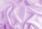 Satin silk fabric purple color for the background. Crumpled wavy silk. Texture of satin fabric