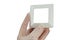 Satin white design plastic light switch frame held in fingers of left hand in transparent latex safety glove, white background