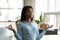 Satisfied african american businesswoman relaxing, meditating in yoga pose breathing exercises.