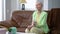 Satisfied beautiful middle aged woman drinking refreshing water from glass in slow motion smiling. Portrait of positive