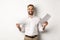 Satisfied boss smiling while holding good report, reading documents, standing over white background