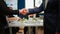 Satisfied businessman company employer wearing suit handshake new employee