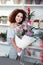 Satisfied curly-haired young girl showing her flower masterpiece