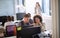 Satisfied female boss looking at employees work in open space office with other workers in the background. modern business concept