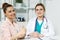 Satisfied happy female patient with medicine doctor at her office