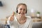 Satisfied happy girl wearing headset showing thumbs up giving recommendation