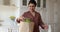 Satisfied Indian housewife unpack internet order delivery with fresh greenery