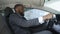 Satisfied man in business suit sitting in car, successful purchase, happiness