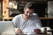 Satisfied man doing paperwork in cafe, holding letter or legal document