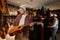 Satisfied man musician glad to choose new acoustic guitar for performance