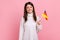 Satisfied positive female holding German flag in her hand and looking at camera with toothy smile.