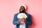 Satisfied rich african-american man showing money, smiling pleased and show-off with income, standing with dollars over