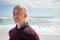 Satisfied senior man thinking at beach