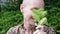 Satisfied smiling bald woman holding mint leaves in her hands. mental health