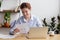 Satisfied smiling woman sitting at desk working with business papers