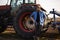 Satisfied tractor driver after work on agricultural field stands next to tractor