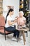 Satisfied volunteer helping senior woman