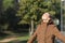 Satisfied woman breathing fresh air in a park