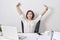 Satisfied woman relaxing with hands behind her head. Happy smiling employee after finish work, reading good news, break at work,