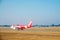 SATTAHIP, THAILAND - 21 DEC - Air Asia airline\'s passenger plane at U-Tapao airport with dried grass ground in Thailand
