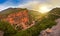 Saturated color of the mountain of the Atlas on a sunset in Morocco, on a slope of mountains winds the road