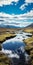 Saturated Color Scheme: Stunning Stream In Grassy Plain With Majestic Mountains