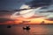 Saturn back on night cloud sunset sky silhouette boat on sea