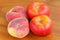 Saturn Peaches and Flat Nectarines on a wooden background