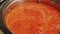 Sauce for cooking jollof rice. Tomato and red pepper sauce simmering in a saucepan