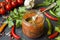 Sauce ketchup, Lecho in glass jar. Chili tomato cherry garlic and other spices on black background