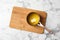 Saucepan with melting butter on marble background, top view.