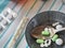 Saucer and thermometer on a towel, which is spread on the table. In a saucer, medicine and a spoon with pills.