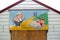 Saucy postcard beach hut painting